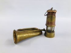 A MILITARY BRASS BUGLE WITH BROAD ARROW STAMP PLUS MINERS LAMP.