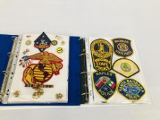 TWO ALBUMS CONTAINING AMERICAN MILITARY CLOTH BADGES, POLICE BADGES ETC.