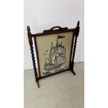 A VINTAGE OAK FIRE SCREEN INSET WITH A SHIPPING RELATED NEEDLEWORK PANEL H 81 X W 62CM.