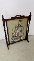 A VINTAGE OAK FIRE SCREEN INSET WITH A SHIPPING RELATED NEEDLEWORK PANEL H 81 X W 62CM.