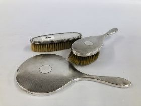 A VINTAGE SILVER BACKED DRESSING MIRROR AND BRUSH, LONDON ASSAY + A FURTHER BRUSH BIRMINGHAM ASSAY.