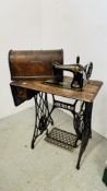 A VINTAGE SINGER SEWING MACHINE ON CAST METAL BASE - SOLD AS SEEN.