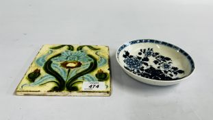 A MAJOLICA STYLE TILE ALONG WITH AN ORIENTAL BLUE AND WHITE SAUCER.