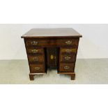 A SMALL ANTIQUE MAHOGANY 7 DRAWER DESK INLAID STRING DETAIL ON BRACKET FOOT - W 71CM X 55CM X 75CM.