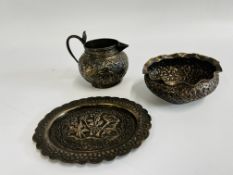 3 PIECES OF INDIAN EMBOSSED WHITE METAL TO INCLUDE JUG, BOWL AND PLATE.