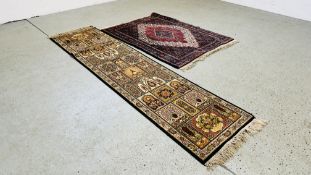 AN EASTERN RED / BLUE PATTERNED RUG 157 X 122CM AND A MODERN MACHINE MADE PATTERNED HALL RUNNER 270
