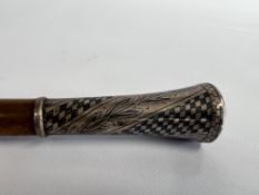 A WHITE METAL HANDLED VINTAGE CANE,