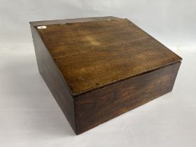 AN ANTIQUE OAK CLARK'S DESK WITH PART FITTED INTERIOR AND BRASS HINGES.