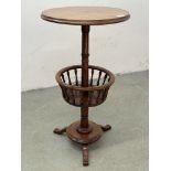 AN ANTIQUE VICTORIAN CIRCULAR LAMP TABLE WITH LOWER CIRCULAR BASKET AND TURNED SUPPORTS ON TRIPOD