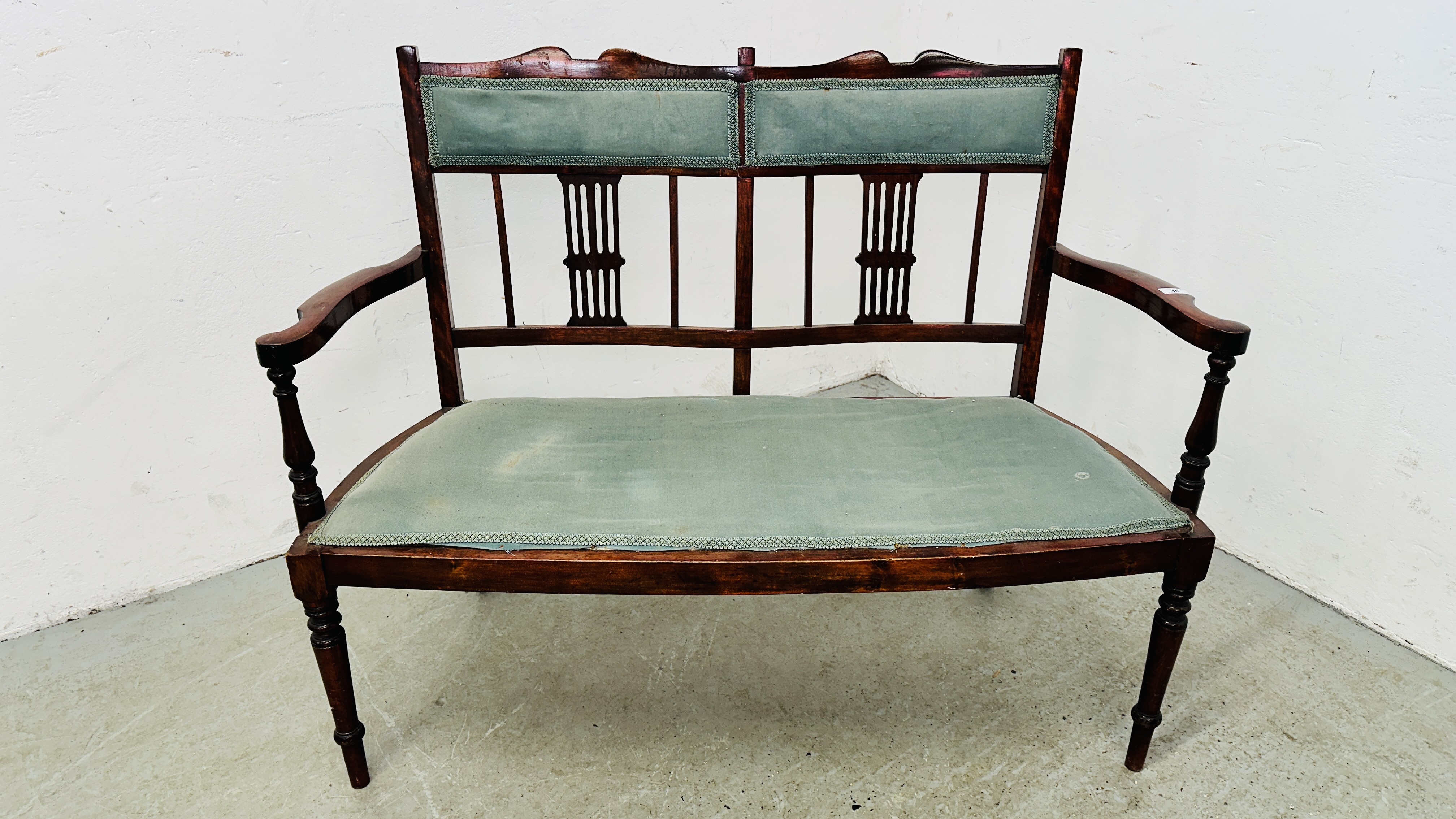 EDWARDIAN MAHOGANY 2 SEAT SOFA WITH FRETT WORK SUPPORT BACK AND GREEN UPHOLSTERY.