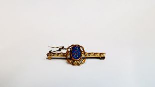A VINTAGE BROOCH MARKED 9CT SET WITH AN OPAL.