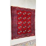 A RED AND BLUE PATTERNED EASTERN RUG - 125 X 108CM.