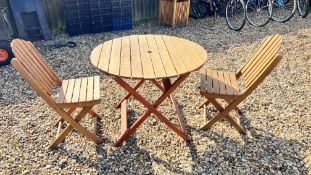 A CIRCULAR FOLDING HARDWOOD GARDEN TABLE AND TWO FOLDING CHAIRS.
