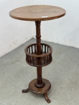 AN ANTIQUE VICTORIAN CIRCULAR LAMP TABLE WITH LOWER CIRCULAR BASKET WITH TURNED SUPPORTS ON A