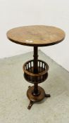 AN ANTIQUE VICTORIAN CIRCULAR LAMP TABLE WITH LOWER CIRCULAR BASKET WITH TURNED SUPPORTS ON A