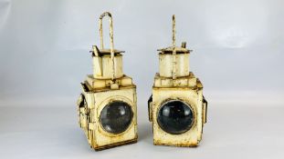A PAIR OF WHITE PAINTED VINTAGE RAILWAY LAMPS - HEIGHT 47CM.