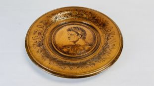 A POKERWORK HARDWOOD DISH DECORATED WITH A CLASSICAL BUST - DIAM 36CM.