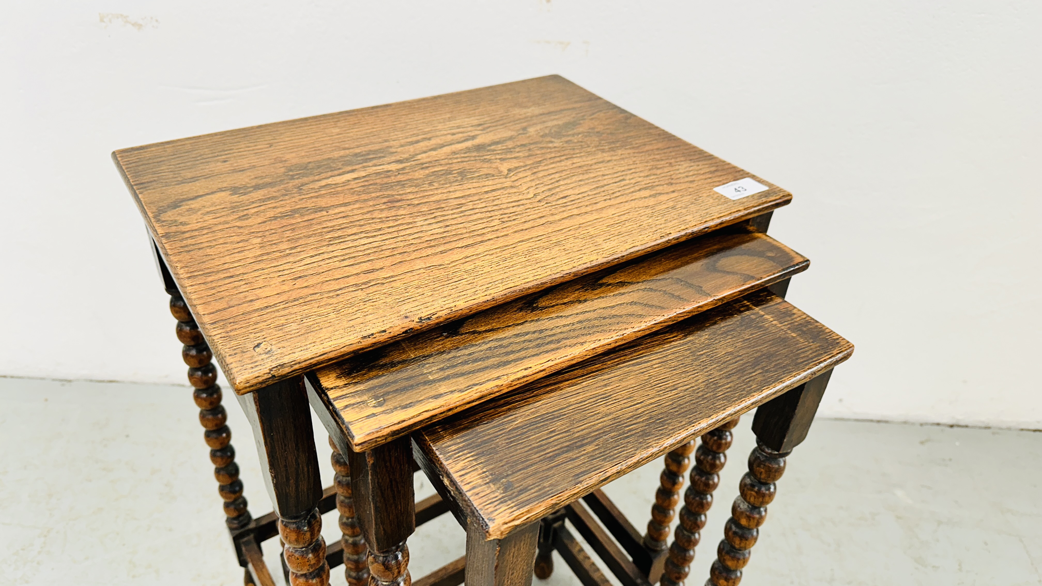 A NEXT TO 3 GRADUATED OCCASIONAL TABLES ON BOBBIN TURNED SUPPORTS - H 55CM X W 42CM X D 30CM. - Image 2 of 9