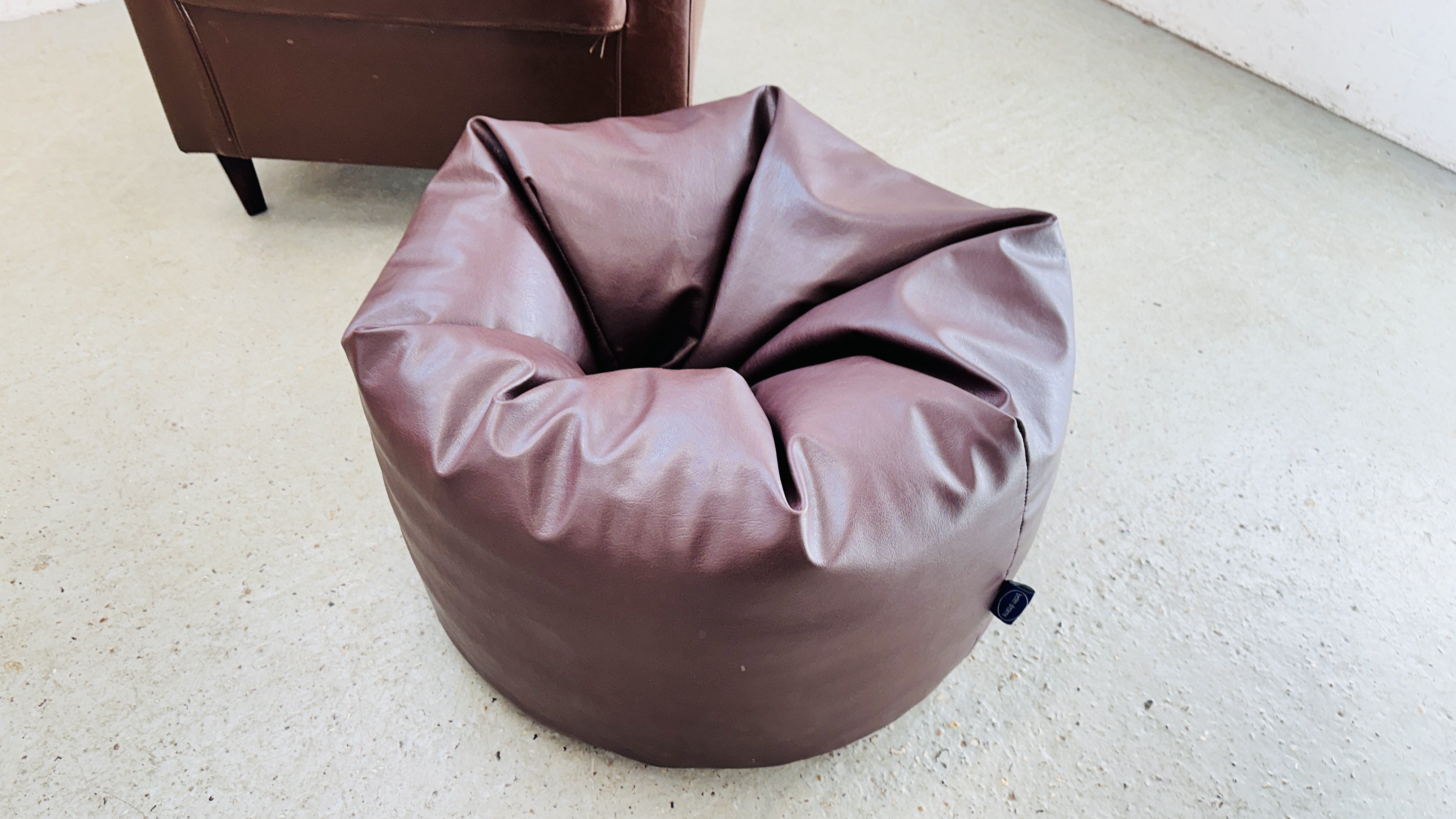 A MODERN BROWN FAUX LEATHER TUB CHAIR ALONG WITH MATCHING BEAN BAG FOOT REST. - Image 9 of 11