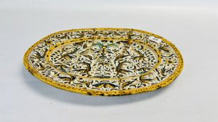 AN C18TH CONTINENTAL FAIENCE DISH DECORATED WITH BIRDS AND WINGED HEADS WITHIN YELLOW BORDERS,
