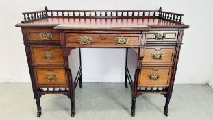 A VICTORIAN MAHOGANY LEATHER TOP DESK WITH GALLERY SURROUND ON CERAMIC CASTORS - W 111CM X D 61CM X