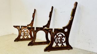 A PAIR OF ANTIQUE GREAT EASTERN RAILWAY DECORATIVE CAST BENCH ENDS AND CENTRE SUPPORT.