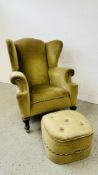 A GREEN VELOUR WINGBACK ARMCHAIR AND MATCHING FOOTSTOOL.