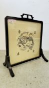 AN ORIENTAL FIRE SCREEN FRAMING AN EMBROIDERED DRAGON - 62CM W X 72CM H.