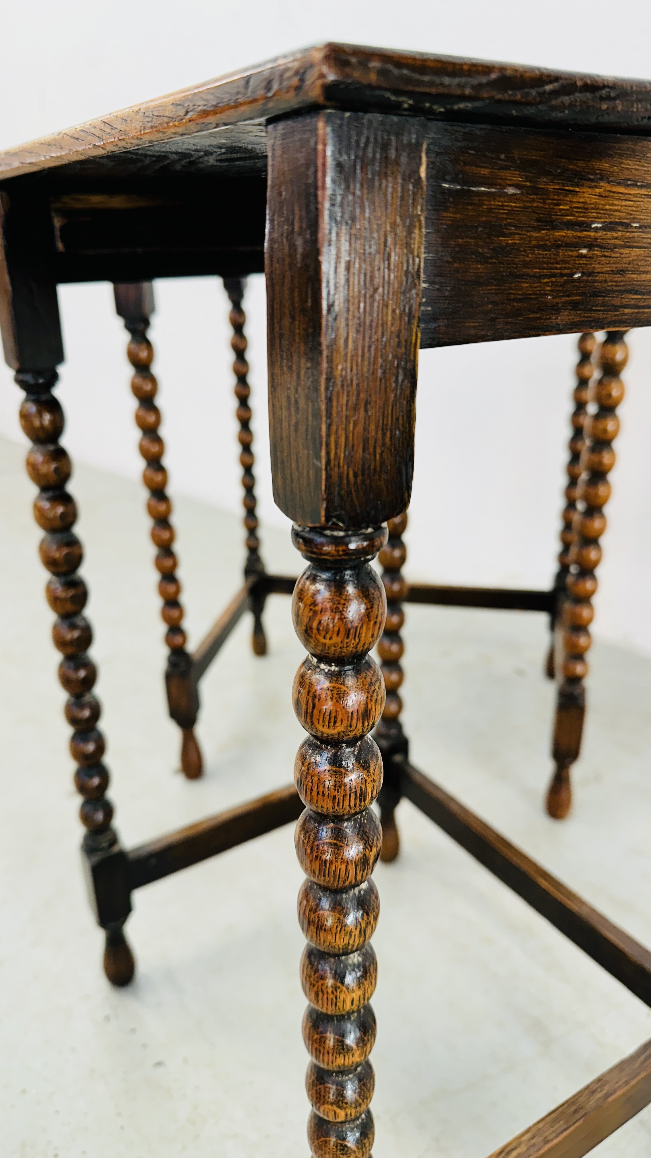 A NEXT TO 3 GRADUATED OCCASIONAL TABLES ON BOBBIN TURNED SUPPORTS - H 55CM X W 42CM X D 30CM. - Image 9 of 9