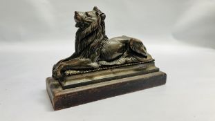 A C19TH BRONZE MODEL OF A LION ON AN OAK BASE, 33CM LONG 22CM H.