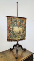 A VICTORIAN MAHOGANY POLE SCREEN, THE TAPESTRY SCREEN DECORATED WITH FLOWERS AND SQUIRREL.