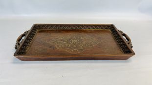 AN ORIENTAL TWO HANDLED CARVED HARDWOOD AND BRASS INLAID TRAY, L 61 X W 37.