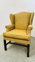 A HIGH SEAT WINGBACK EASY CHAIR WITH CARAMEL UPHOLSTERY.