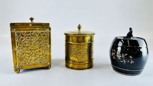 TWO VINTAGE BRASS CADDIES ALONG WITH A VINTAGE BLACK GLAZED TOBACCO JAR DECORATED WITH BLOSSOM.