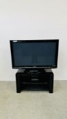 A PANASONIC 42" FULL SCREEN TV ON MODERN BLACK FINISH STAND - SOLD AS SEEN.