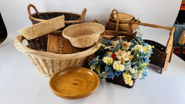 A TWO HANDLED WICKER LOG BASKET ALONG WITH APPROXIMATELY 14 FURTHER WICKER AND WOVEN BASKETS AND A