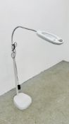 A FLOOR STANDING ANGLE POISE ILLUMINATED MAGNIFYING WORK LAMP - SOLD AS SEEN.