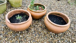 A GROUP OF 3 SIMILAR TERRACOTTA SQUATTED GARDEN PLANTERS