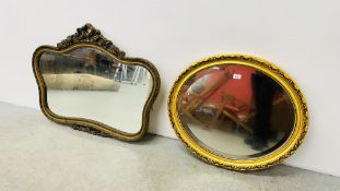 AN OVAL GILT BEVELED WALL MIRROR ALONG WITH A FURTHER ELABORATE GILT FINISH OVER MANTEL MIRROR.
