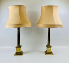 A PAIR OF HEAVY GILT FINISHED COLUMNED TABLE LAMPS - WIRES REMOVED.