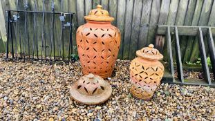 TWO TERRACOTTA URNS OF PIECED DESIGN COMPLETE WITH LIDS, 1 LARGE, 1 SMALL, THE LARGEST 70CM.
