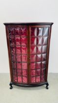 A MAHOGANY GLAZED BOW FRONT DISPLAY CABINET ON BALL AND CLAW FEET.