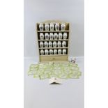 A MODERN CREAM FINISHED SPICE RACK ALONG WITH FRANKLIN MINT SPICE JARS.