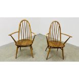 A PAIR OF BLONDE ERCOL WINDSOR STICK BACK CARVER CHAIRS WITH CROSS STRETCHER SUPPORTS.