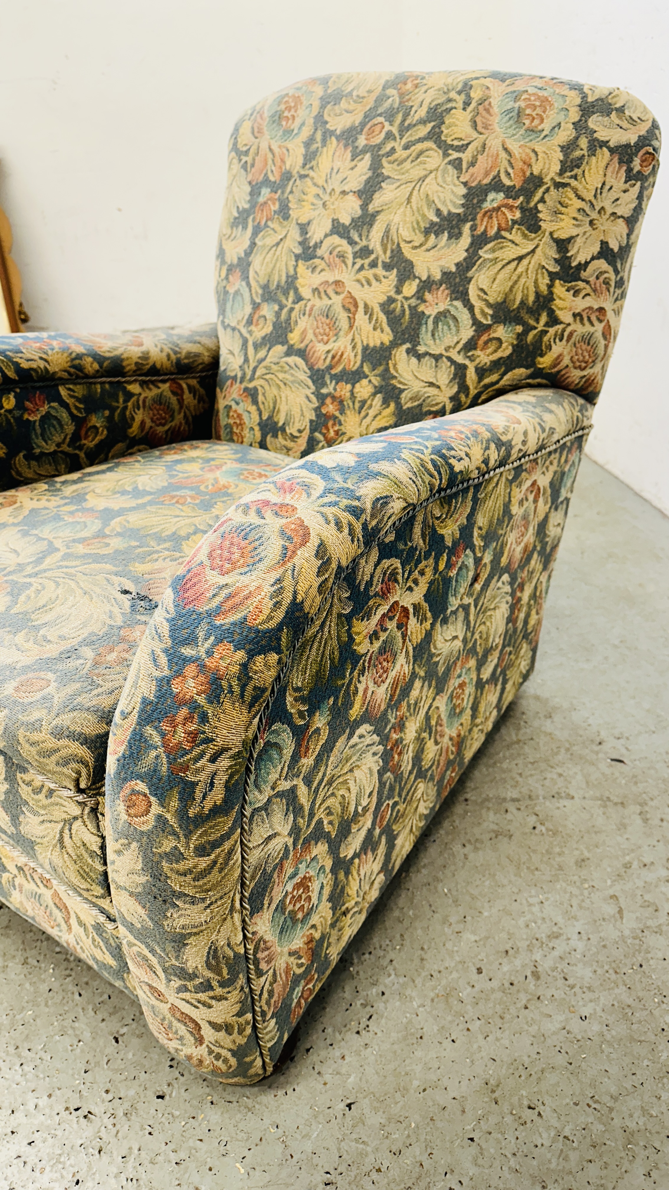 AN ANTIQUE EASY ARMCHAIR ON BUN FEET IN FLORAL UPHOLSTERY. - Image 6 of 6