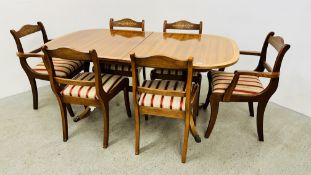 A YEW WOOD FINISH EXTENDING DINING TABLE COMPLETE WITH A SET OF 6 DINING CHAIRS WITH BRASS INLAY.