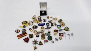 A TUB CONTAINING VINTAGE ENAMELED BADGES.