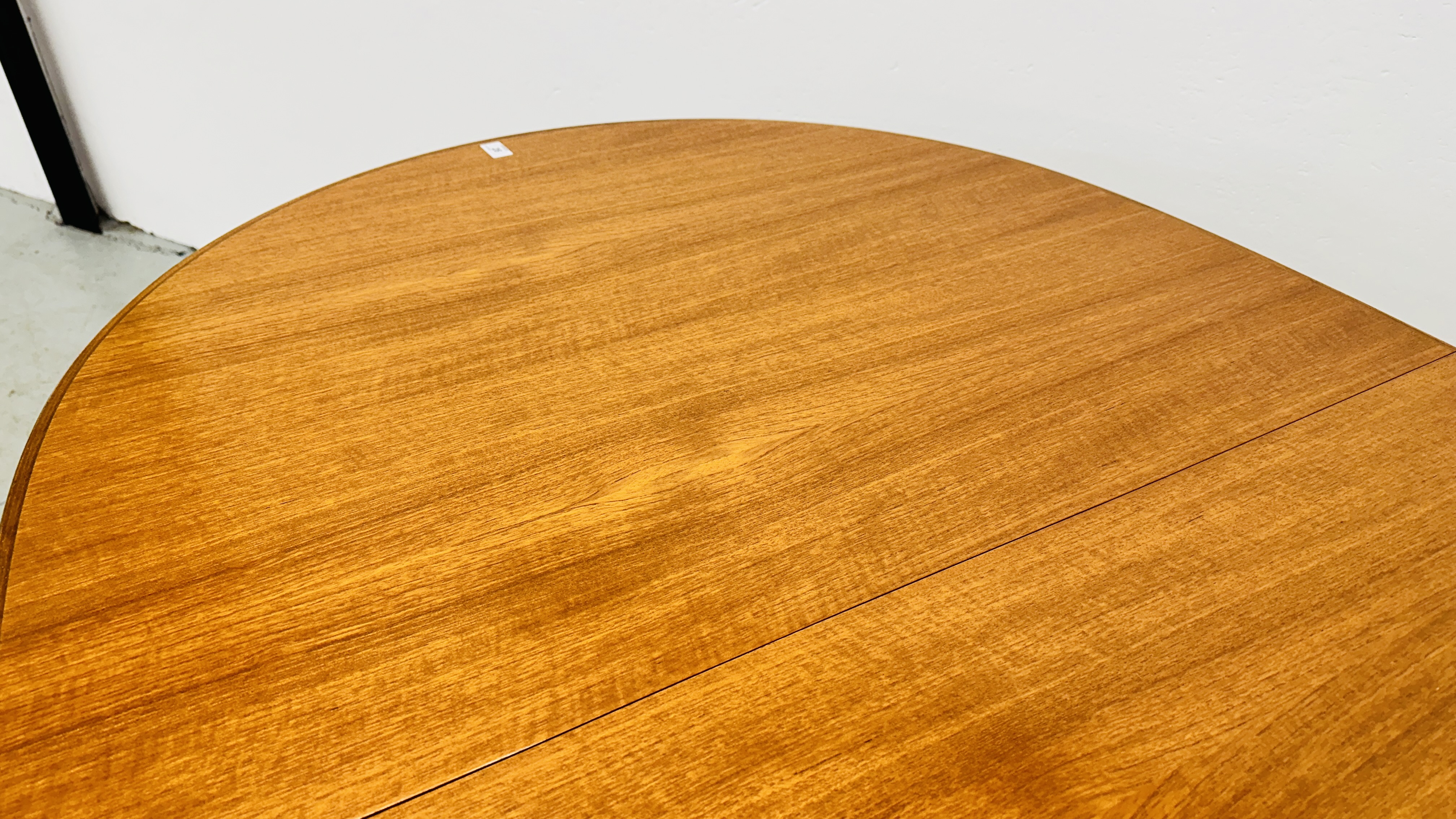 A MID CENTURY TEAK FINISH OVAL EXTENDING DINING TABLE BEARING ORIGINAL MAKERS LABEL "A.H. - Image 8 of 13