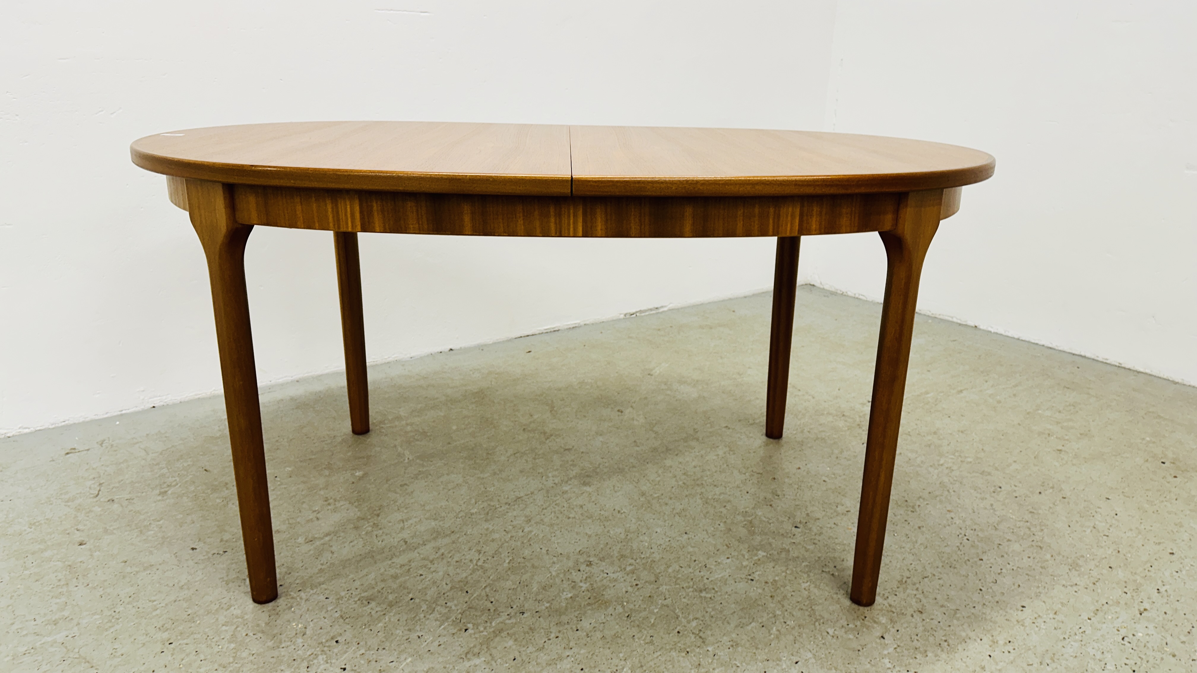 A MID CENTURY TEAK FINISH OVAL EXTENDING DINING TABLE BEARING ORIGINAL MAKERS LABEL "A.H. - Image 2 of 13