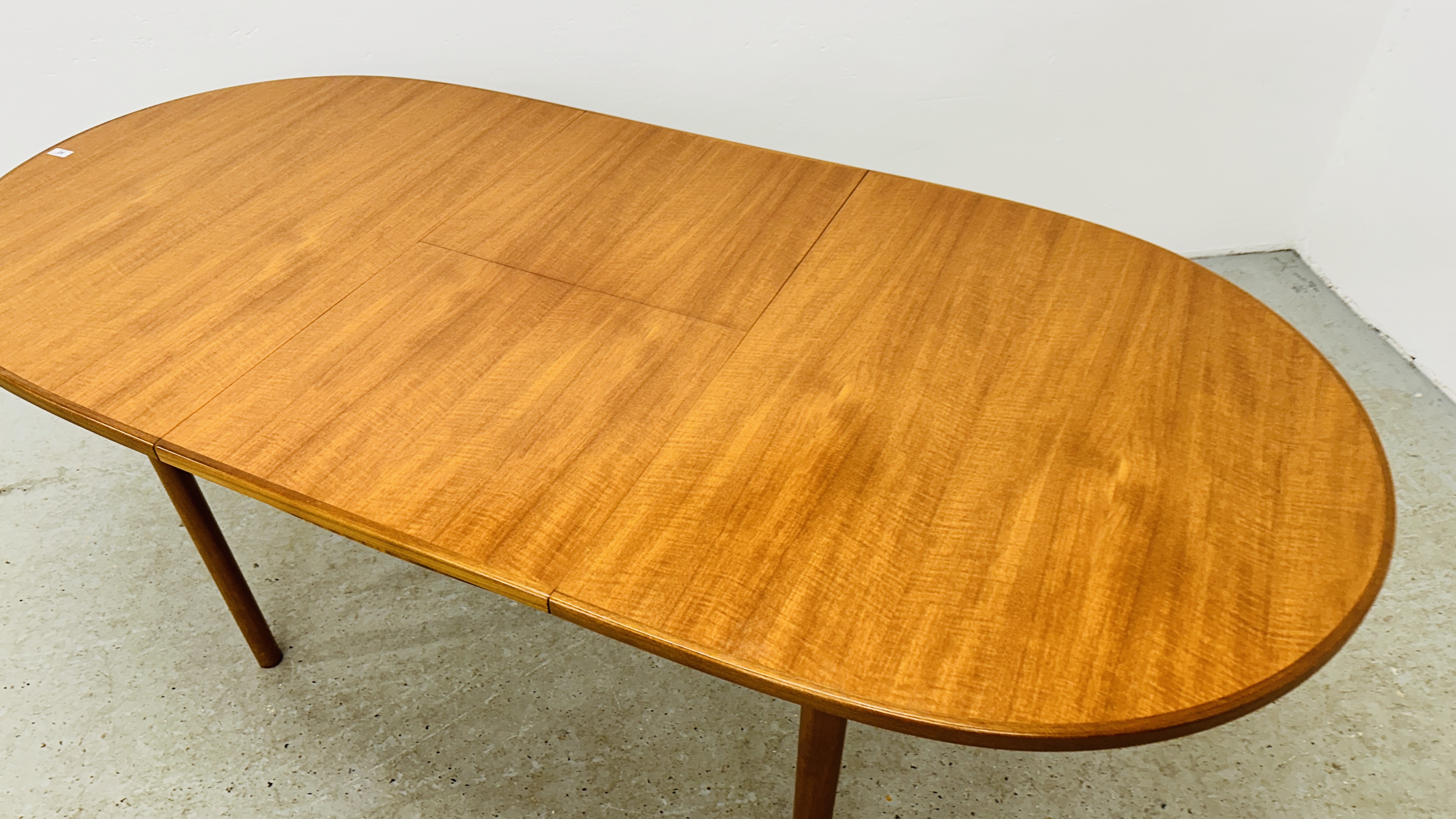 A MID CENTURY TEAK FINISH OVAL EXTENDING DINING TABLE BEARING ORIGINAL MAKERS LABEL "A.H. - Image 10 of 13